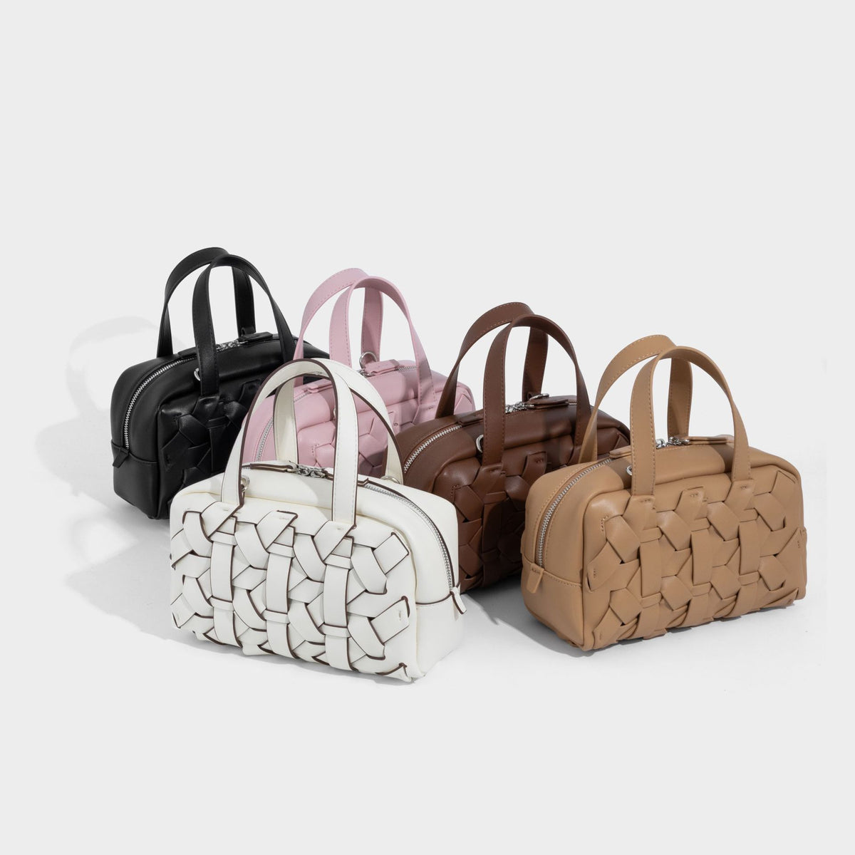 Small structured woven-panel top-handle convertible bag with contrast piping, silver-tone zip closure, and detachable, detail