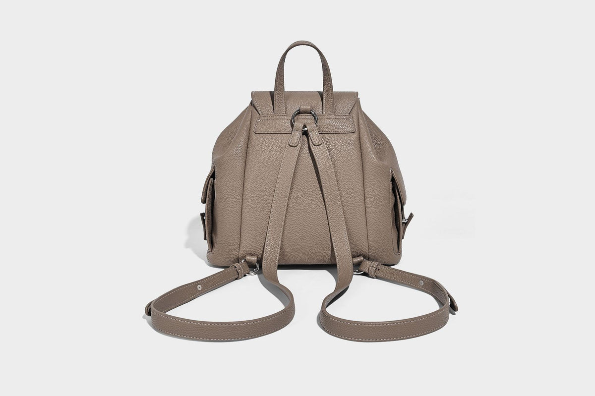 Compact pebbled leather-look flap drawstring backpack handbag with side pockets, top handle, and silver-tone hardware, detail