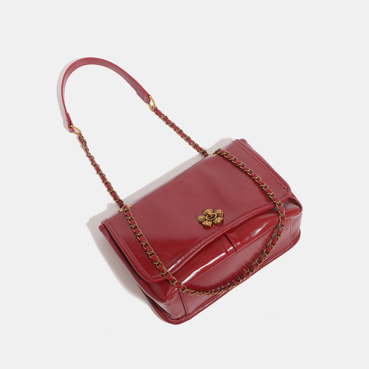 Structured glossy flap shoulder bag with antique gold floral turn-lock clasp and chain-and-leather strap, detail view 4