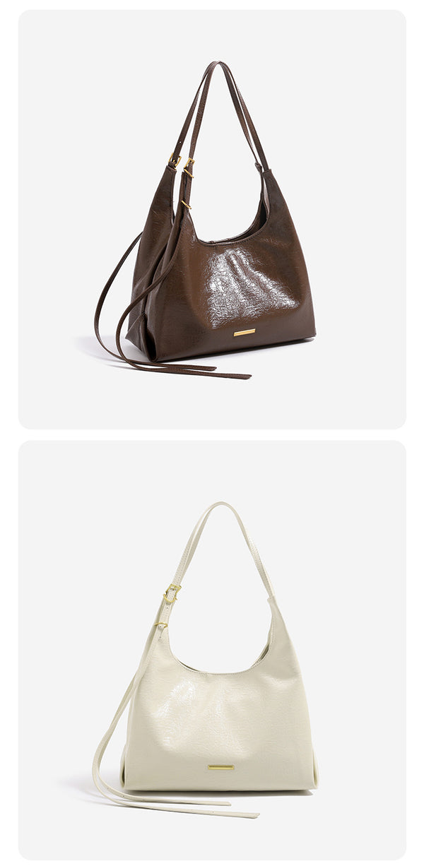 Slouchy hobo shoulder bag in crinkle high-gloss leather-look finish with gold-tone bar hardware and adjustable strap, detail