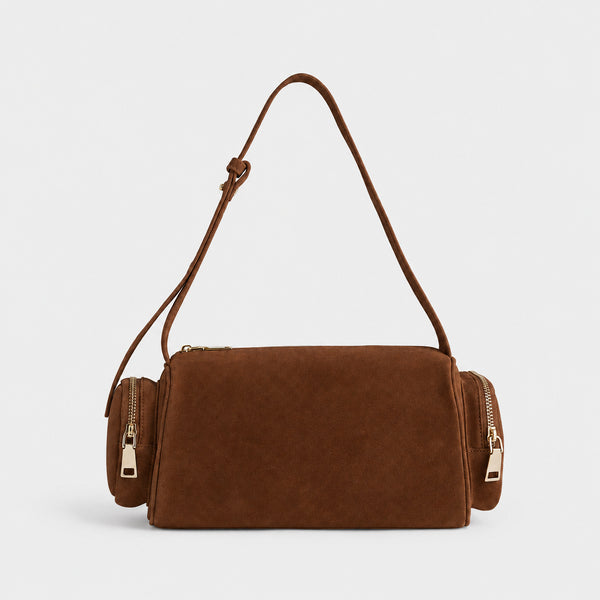 Mini barrel shoulder bag with side zip pouches and adjustable strap in pink suede-like finish, detail view 9