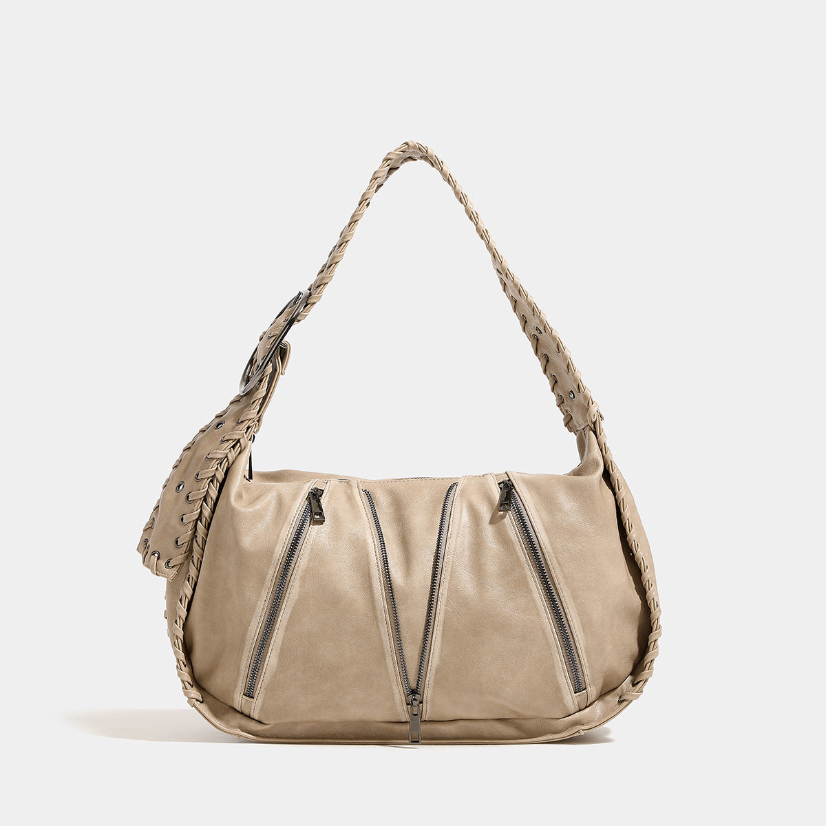 Slouchy hobo shoulder bag with wide braided eyelet strap, multiple front zip compartments, and silver-tone ring buckle