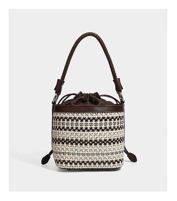 Small structured woven checker bucket bag with braided top handle, drawstring closure, and silver-tone hardware in black