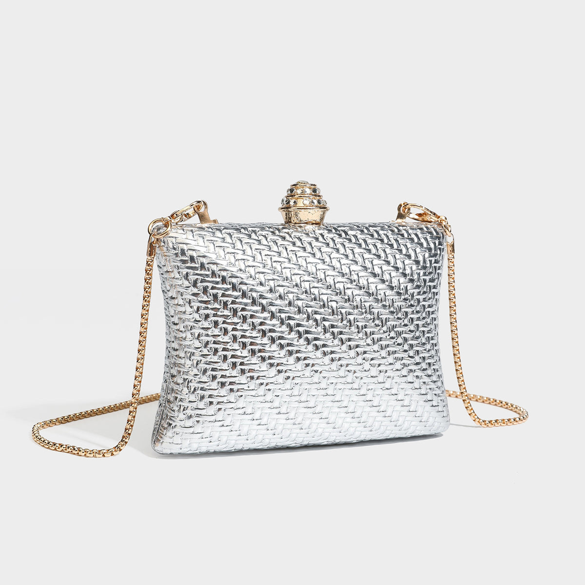 Small structured rectangular metallic woven-texture clutch bag with jeweled knob clasp and gold-tone chain strap, front view
