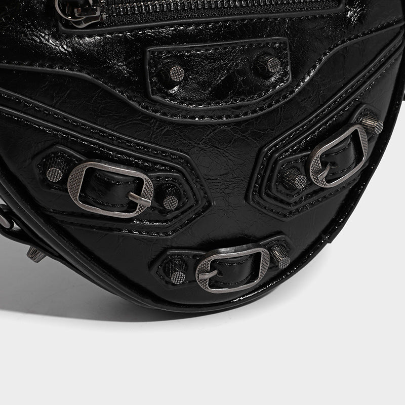 Mini heart-shaped crossbody bag with glossy crinkled finish and moto buckle hardware, detail view 24
