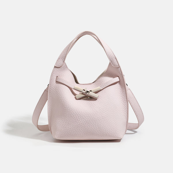 Compact pebbled leather-look shoulder bag with crossed silver-toned metal front closure, short top handle, and long, detail