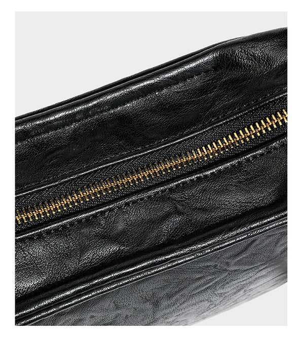 Compact black crinkled leather-look baguette shoulder bag with gold-tone arch hardware and adjustable strap, detail view 20