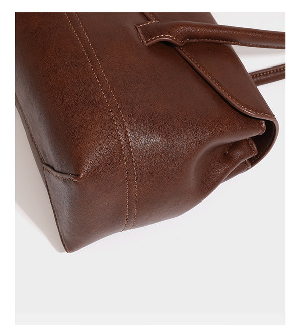 Structured rectangular satchel bag with dual rounded top handles and central metal turn-lock flap closure, detail view 18