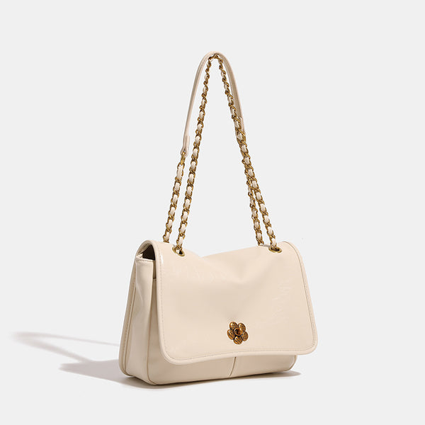 Structured flap shoulder bag with antique gold-tone chain strap and flower turn-lock clasp in crinkled leather-look finish