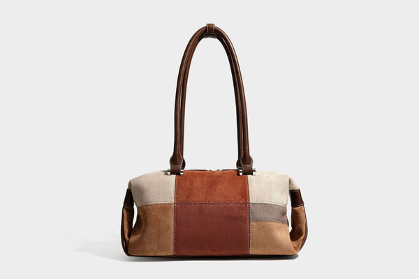 Patchwork suede-look barrel shoulder bag in brown, rust, tan, beige, and gray panels with double leather-look straps and