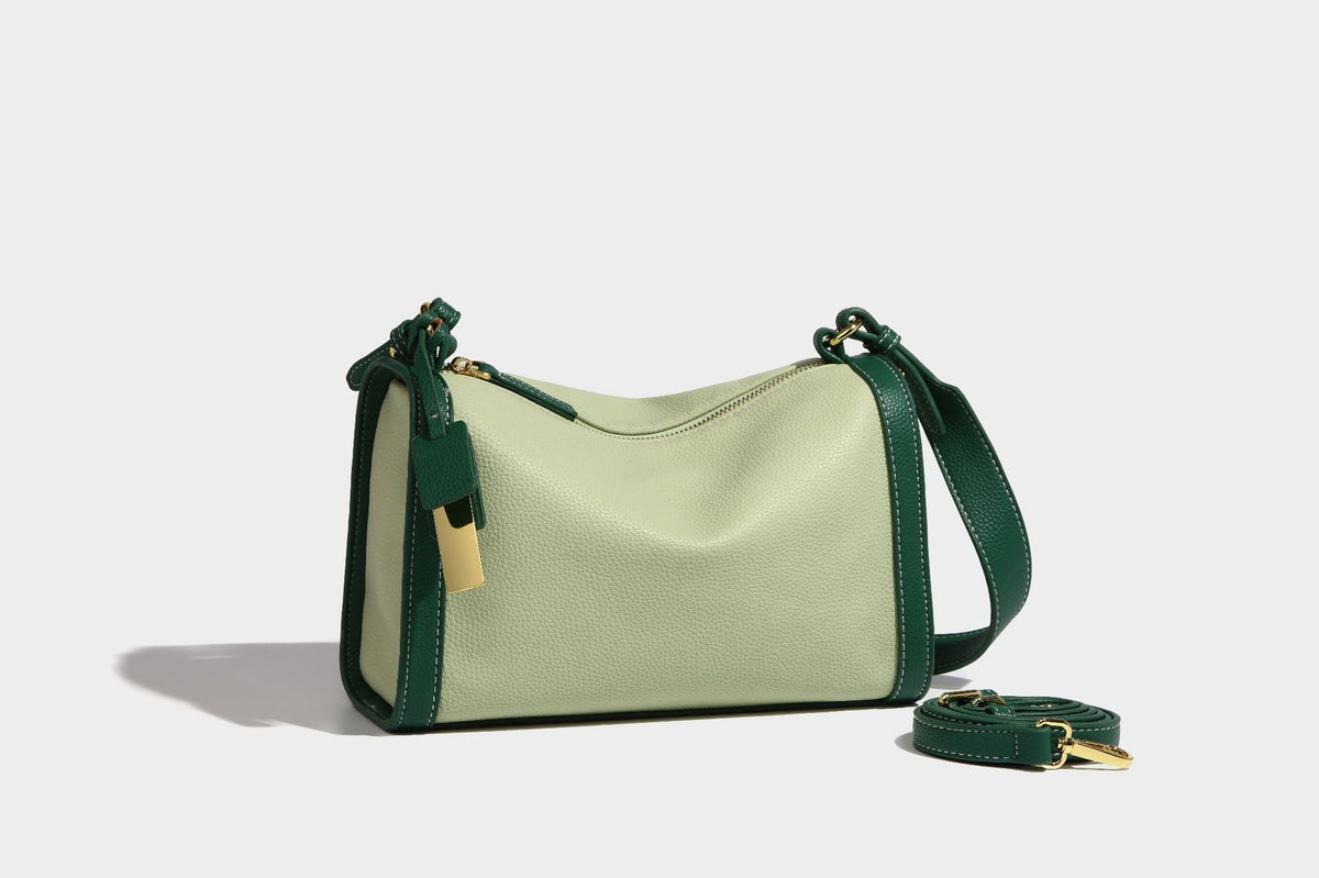 Structured two-tone shoulder bag with pebbled leather-look finish, contrast trim, top zip closure, and gold-tone hardware