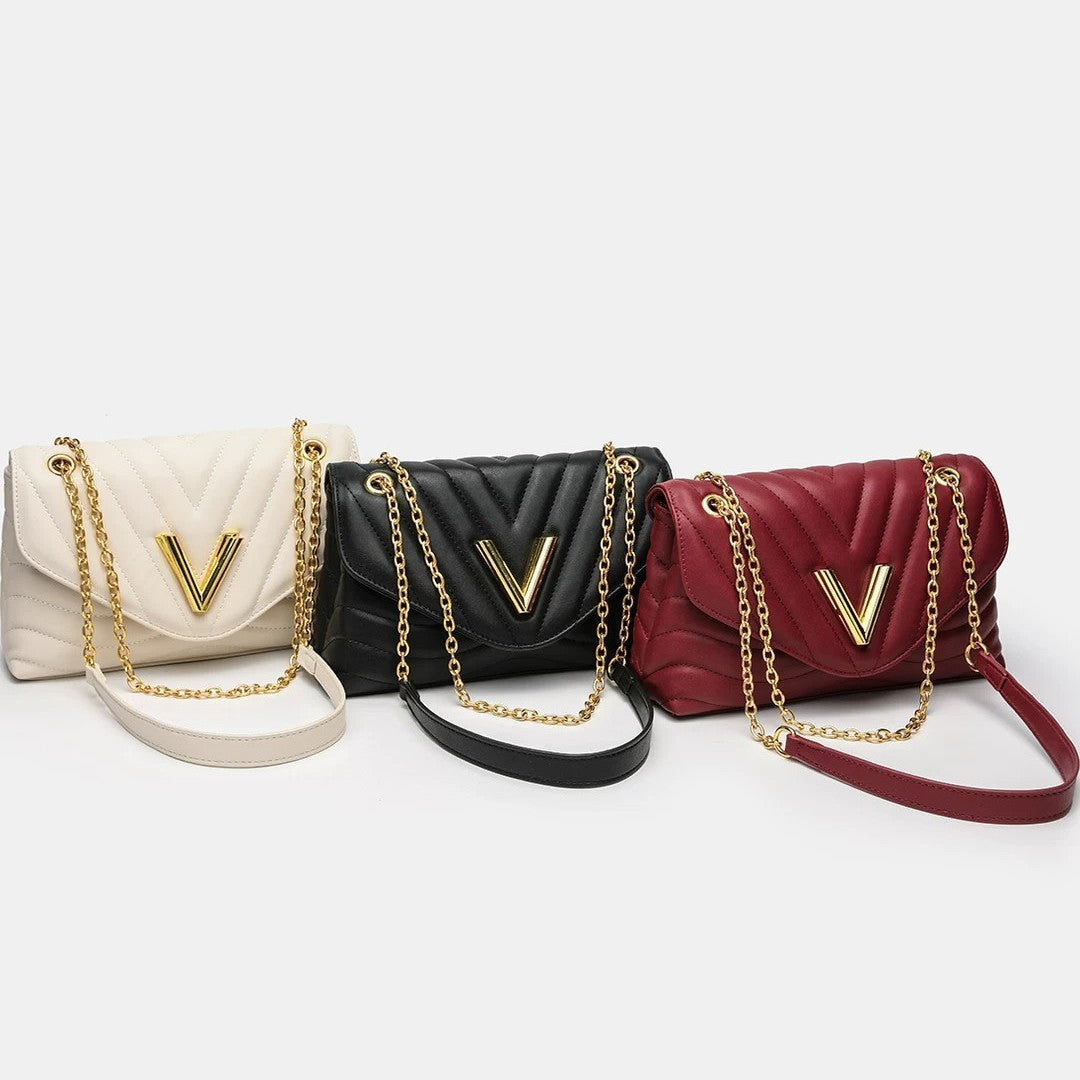 Small structured diamond-quilted flap shoulder bag with gold-tone V-shaped hardware and chain strap, detail view 4
