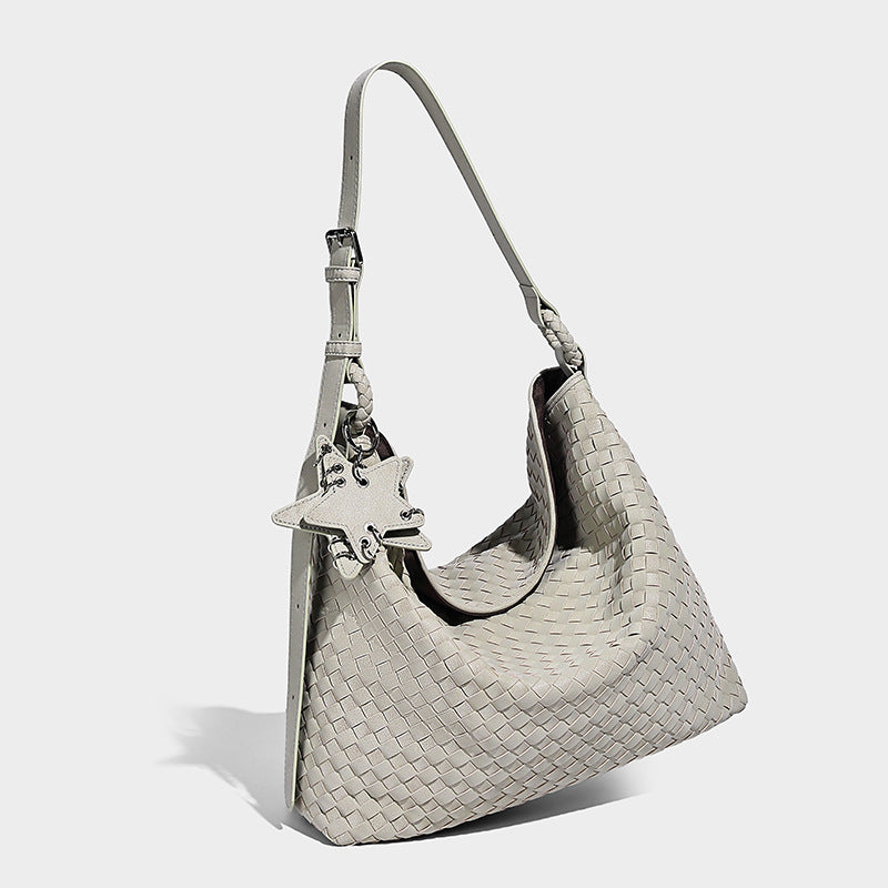 Large soft woven hobo shoulder bag with matte textured finish, adjustable strap, and star charm hardware, detail view 15