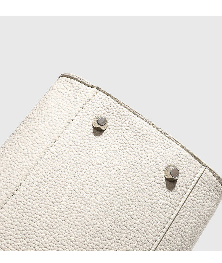 Large structured pebbled leather-look tote bag with double top handles and silver-tone hardware, detail view 16