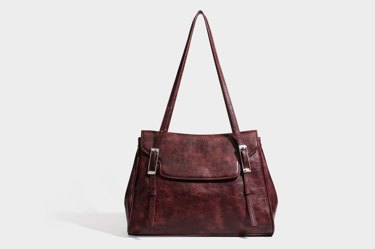 Structured flap-top shoulder tote bag in distressed leather-look finish with silver-tone buckle hardware and double shoulder