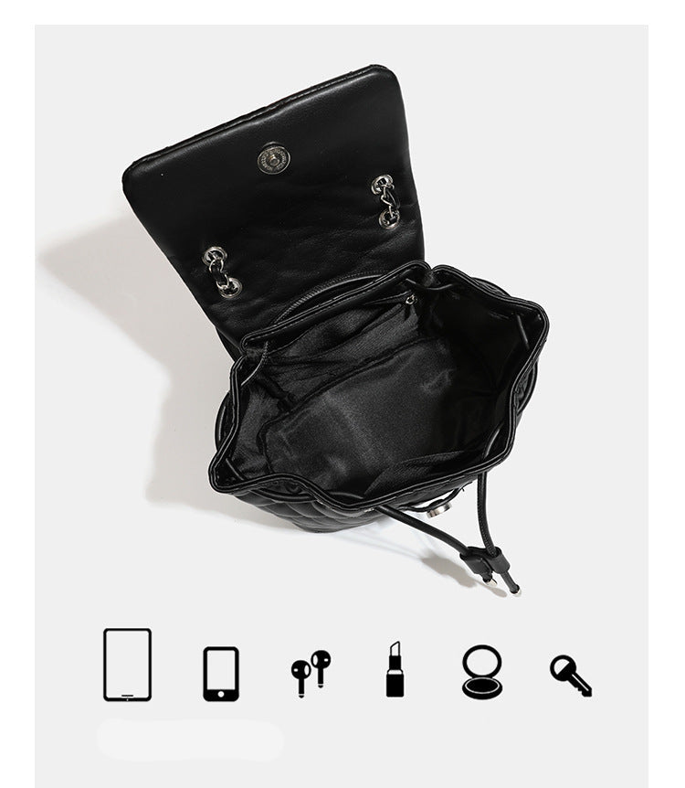 Black diamond-quilted backpack handbag with silver-tone chain flap accent and adjustable shoulder straps, detail view 10