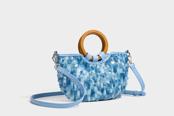 Small sequin half-moon handbag with circular wood-look ring handles and detachable leather-look shoulder strap, detail view