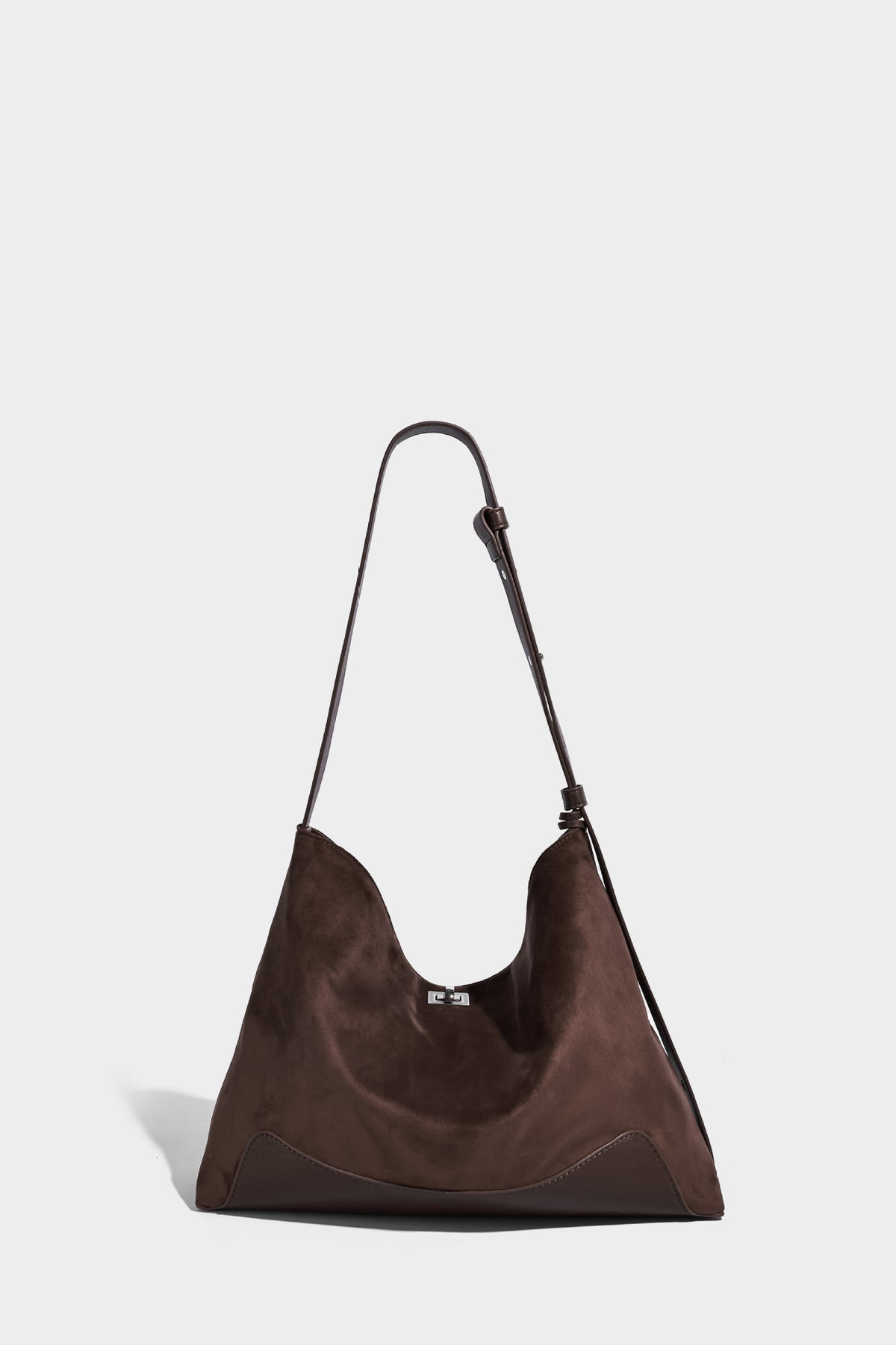 Dark brown slouchy hobo bag with matte suede-look body, smooth leather-look base trim, adjustable shoulder strap, and, detail