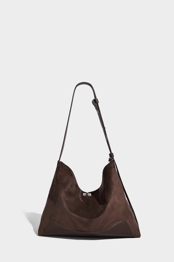 Dark brown slouchy hobo bag with matte suede-look body, smooth leather-look base trim, adjustable shoulder strap, and, detail