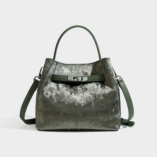 Small structured bucket satchel in embossed velvet-texture fabric with silver turn-lock hardware, rounded top handle, and
