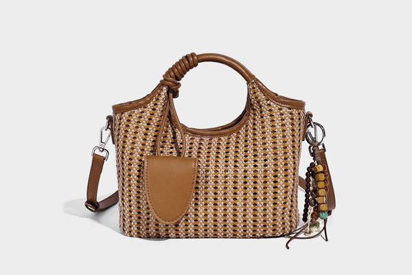 Small structured woven tote crossbody bag with ring top handle, leather-look brown trim, front patch pocket, and detachable