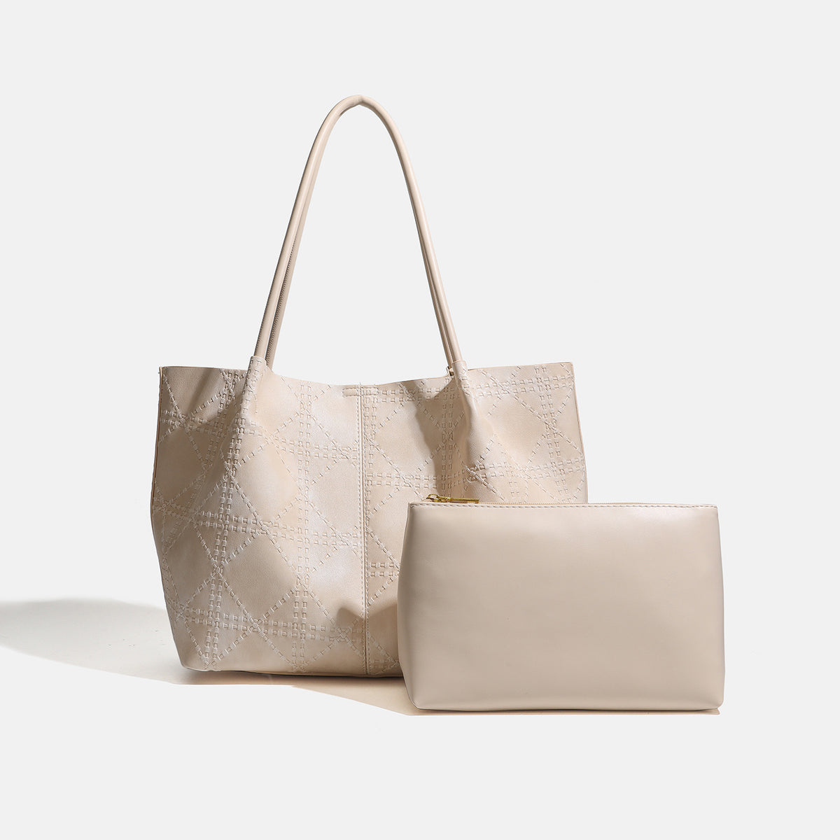 Large open-top tote bag with raised diamond-lattice stitching, long double shoulder handles, and gold-tone magnetic snap
