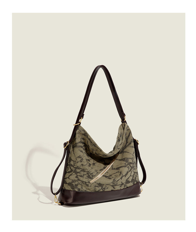 Large ink-wash printed corduroy hobo bag with dark brown leather-look base trim, diagonal front zip pocket, and gold-tone