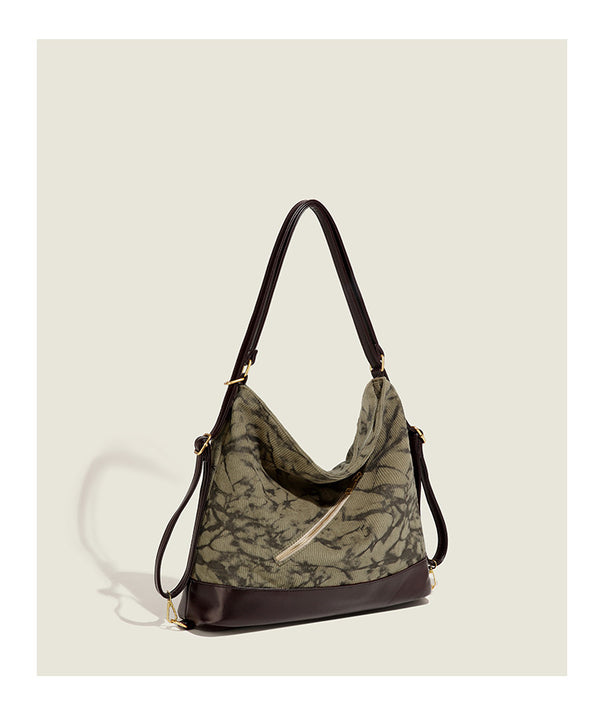 Large ink-wash printed corduroy hobo bag with dark brown leather-look base trim, diagonal front zip pocket, and gold-tone