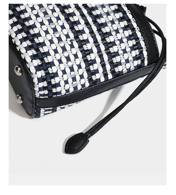 Small structured woven checker bucket bag with braided top handle, drawstring closure, and silver-tone hardware in black