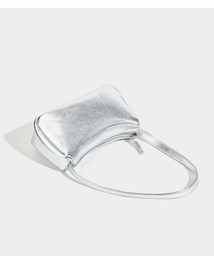 Compact curved silver metallic shoulder bag with top zip closure and slim single strap, detail view 8