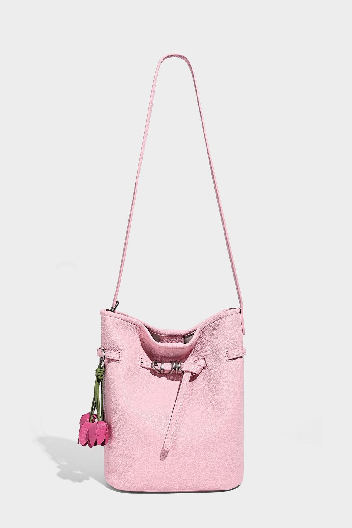 Small pebbled leather-look bucket bag with front drawstring toggle hardware and long adjustable shoulder strap, detail view