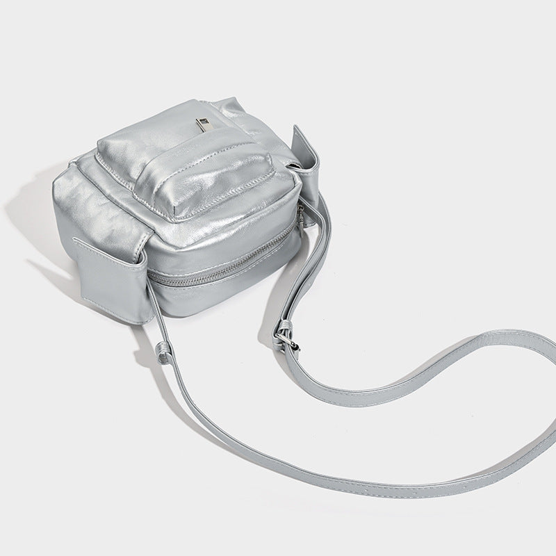 Boxy leather-look crossbody bag with front zip pockets, top zip closure, and long adjustable strap, detail view 4