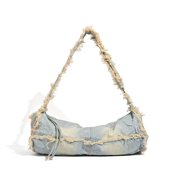 Large slouchy washed denim shoulder bag with frayed raw-edge trim and zip-top closure, detail view 5