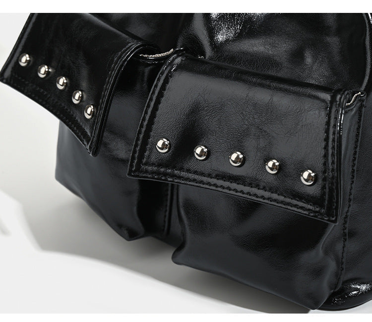 Glossy leather-look drawstring bucket bag with silver dome studs and chain shoulder strap, detail view 9