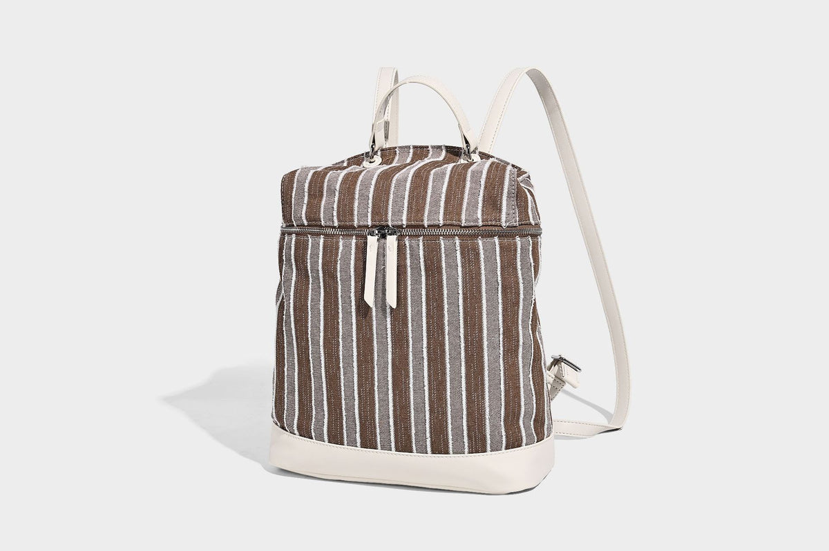 Small structured striped fabric backpack handbag with cream leather-look trim, top handle, and silver-tone hardware, detail