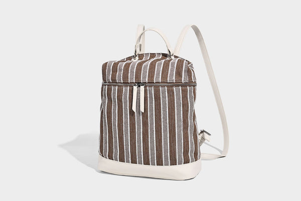 Small structured striped fabric backpack handbag with cream leather-look trim, top handle, and silver-tone hardware, detail