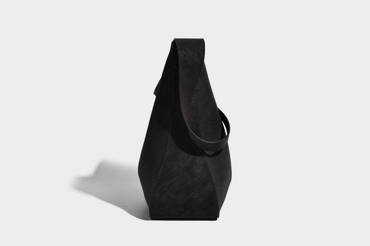 Large slouchy hobo shoulder bag in matte leather-look finish with adjustable strap and gold-tone bar hardware, detail view 22