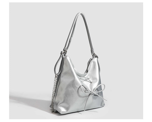 Glossy leather-look hobo shoulder bag with front bow lacing detail and silver-tone chain strap, detail view 24