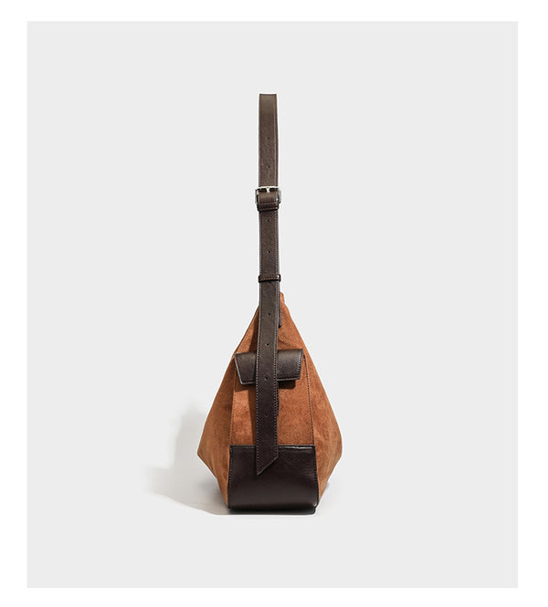 Cognac brown suede-look slouchy shoulder bag with dark brown leather-look trim, top zip closure, exterior side pocket, and