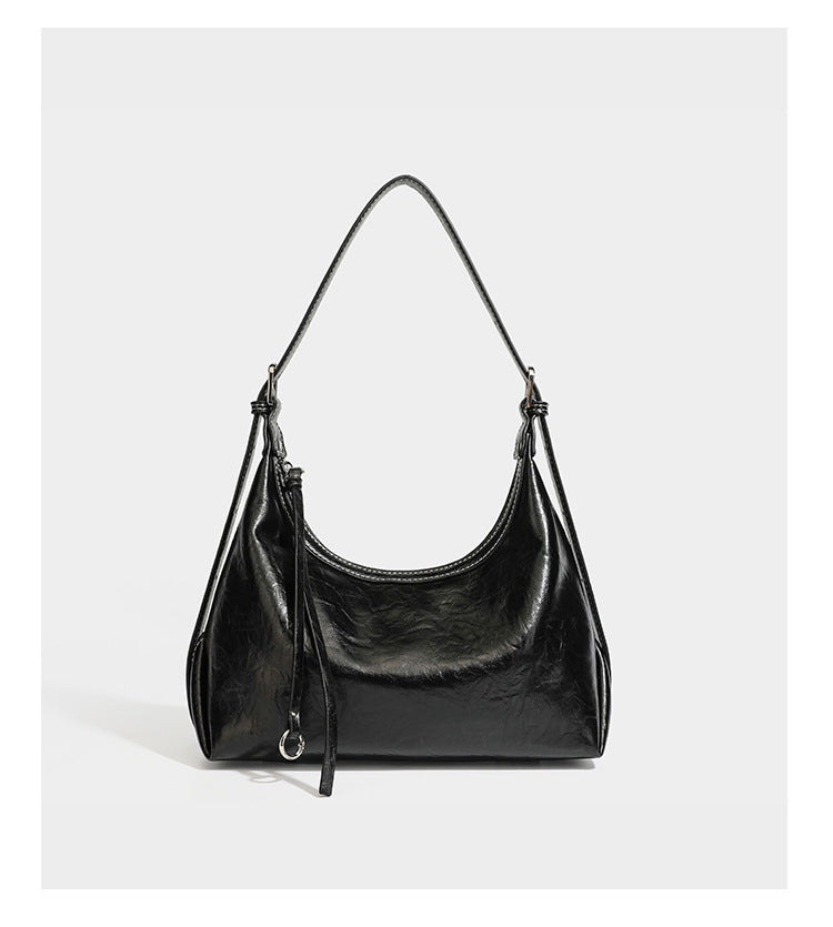 Slouchy hobo shoulder bag in glossy crinkled leather-look finish with zip-top closure and silver-tone ring hardware, detail