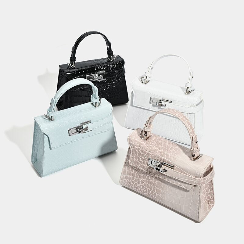 Croc-embossed mini top-handle satchel with silver turn-lock closure and adjustable crossbody strap, detail view 2
