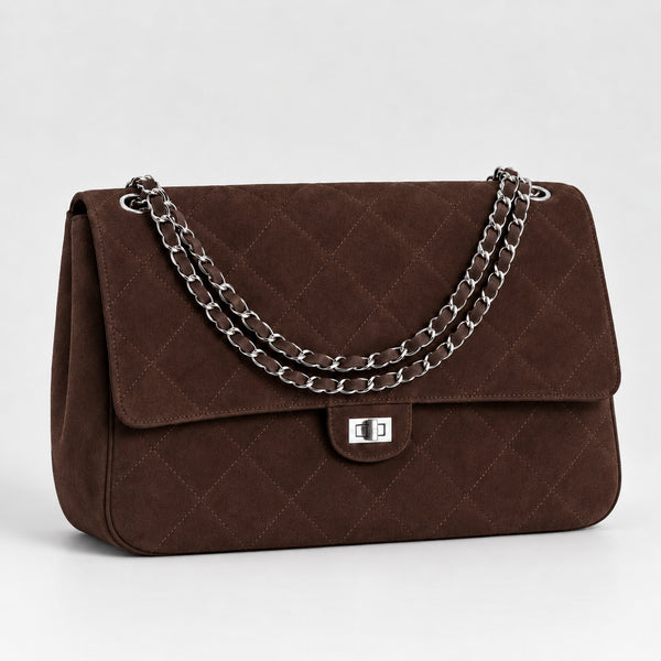 Quilted diamond-stitch flap shoulder bag with double silver chain strap and turn-lock closure in suede-look finish, detail