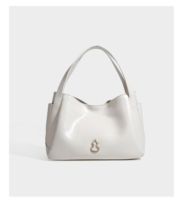 Black glossy crinkled leather-look convertible shoulder tote bag with gold gourd-shaped emblem hardware and detachable