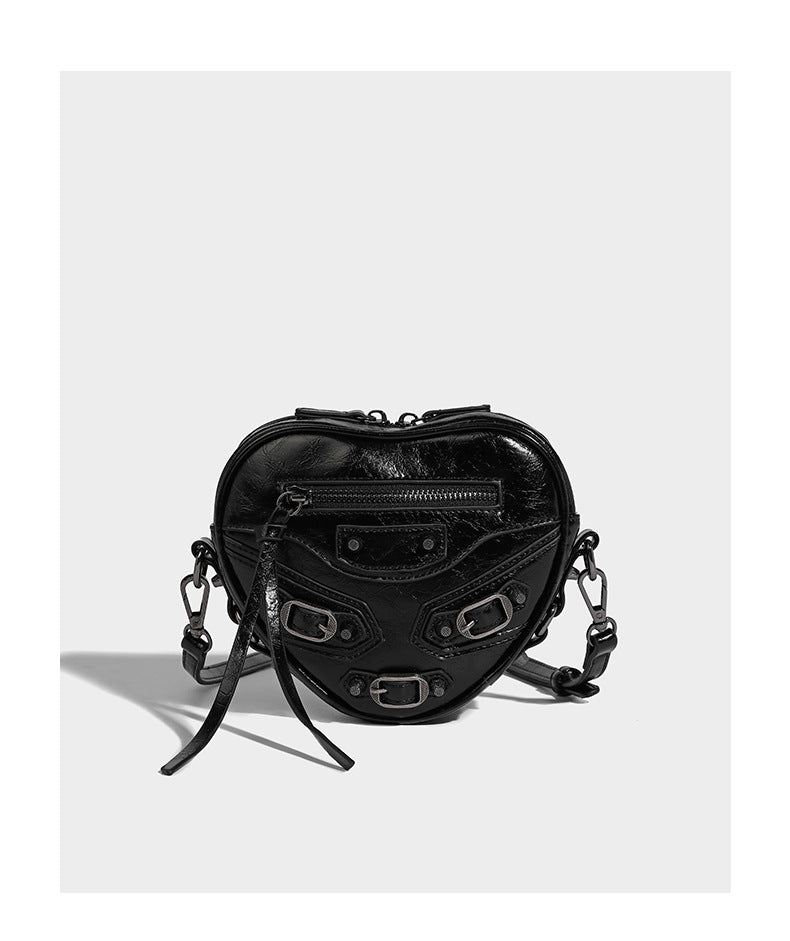 Mini heart-shaped crossbody bag with glossy crinkled finish and moto buckle hardware, detail view 9