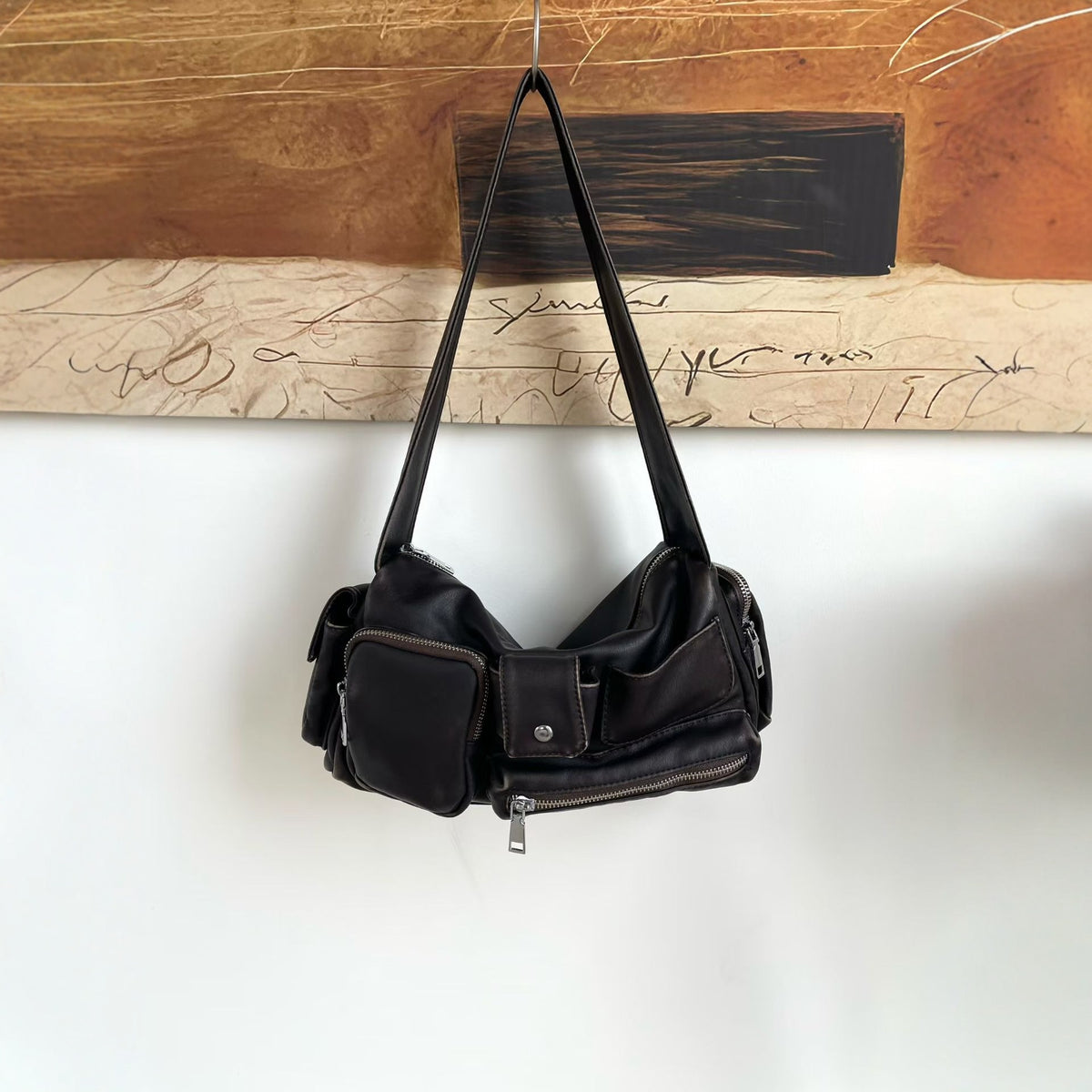 Slouchy multi-pocket leather-look shoulder bag with silver-tone hardware and adjustable strap, detail view 3