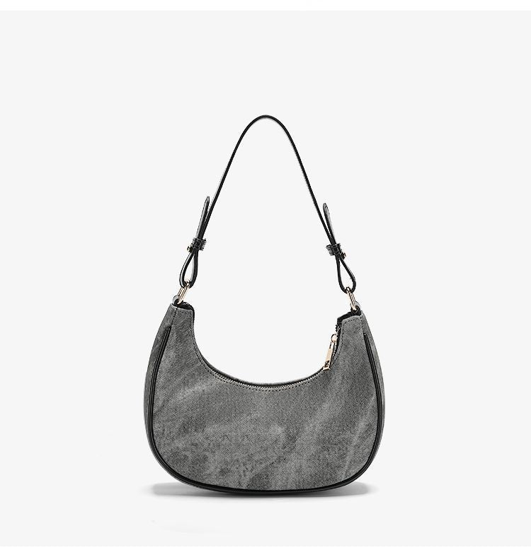 Small gray crescent half-moon shoulder bag with black leather-look trim, gold-tone zipper, and adjustable slim strap, detail