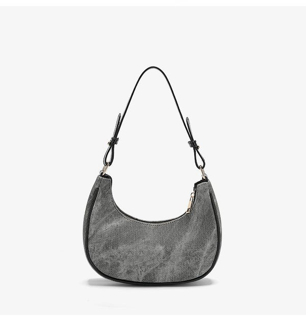 Small gray crescent half-moon shoulder bag with black leather-look trim, gold-tone zipper, and adjustable slim strap, detail