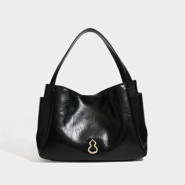 Black glossy crinkled leather-look convertible shoulder tote bag with gold gourd-shaped emblem hardware and detachable