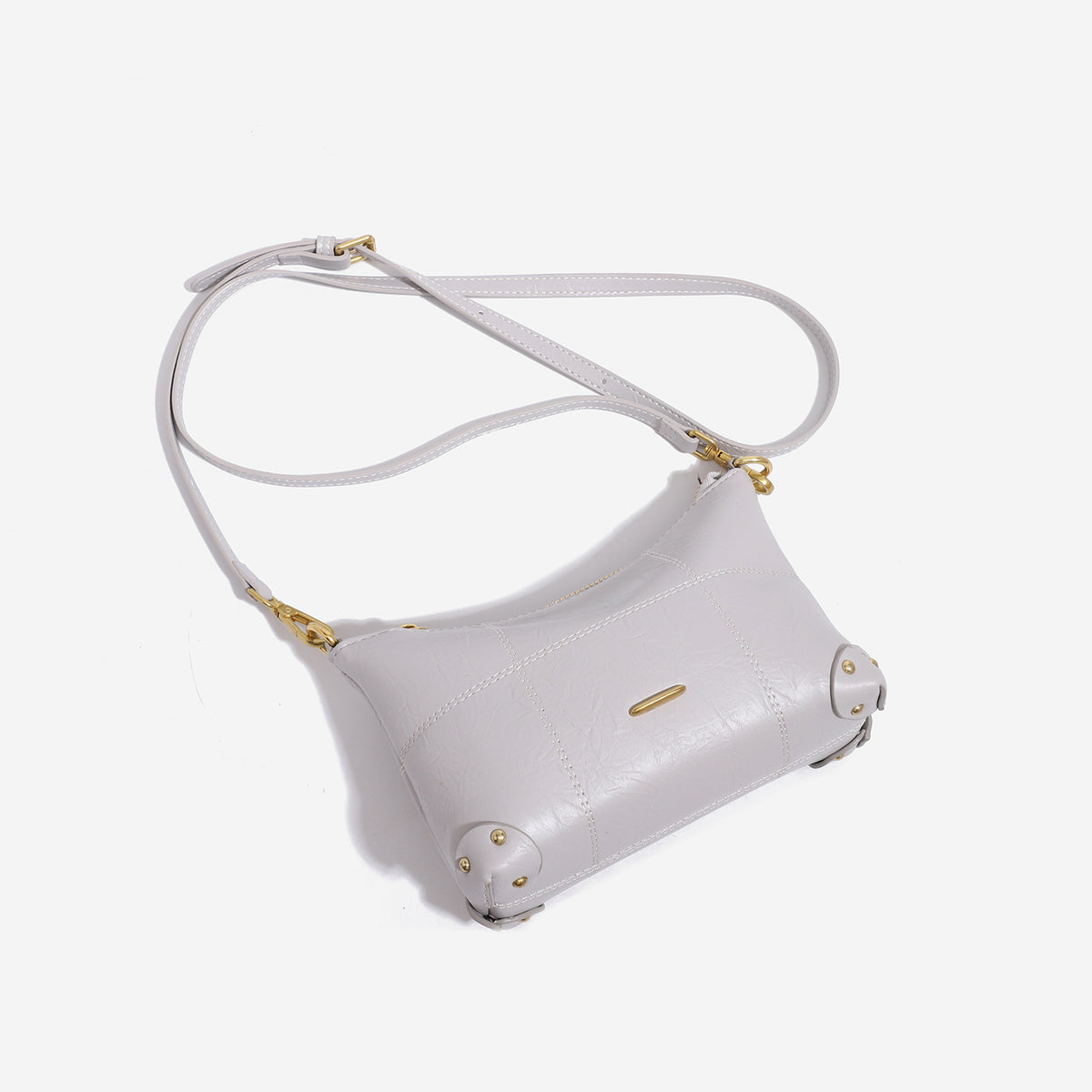 Small soft-structured shoulder bag with curved zip closure, stitched panel detailing, and gold-tone hardware, detail view 4