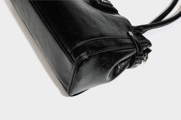 Structured glossy crinkled leather-look satchel with double top handles, front metal-plaque tab, silver-tone hardware, and